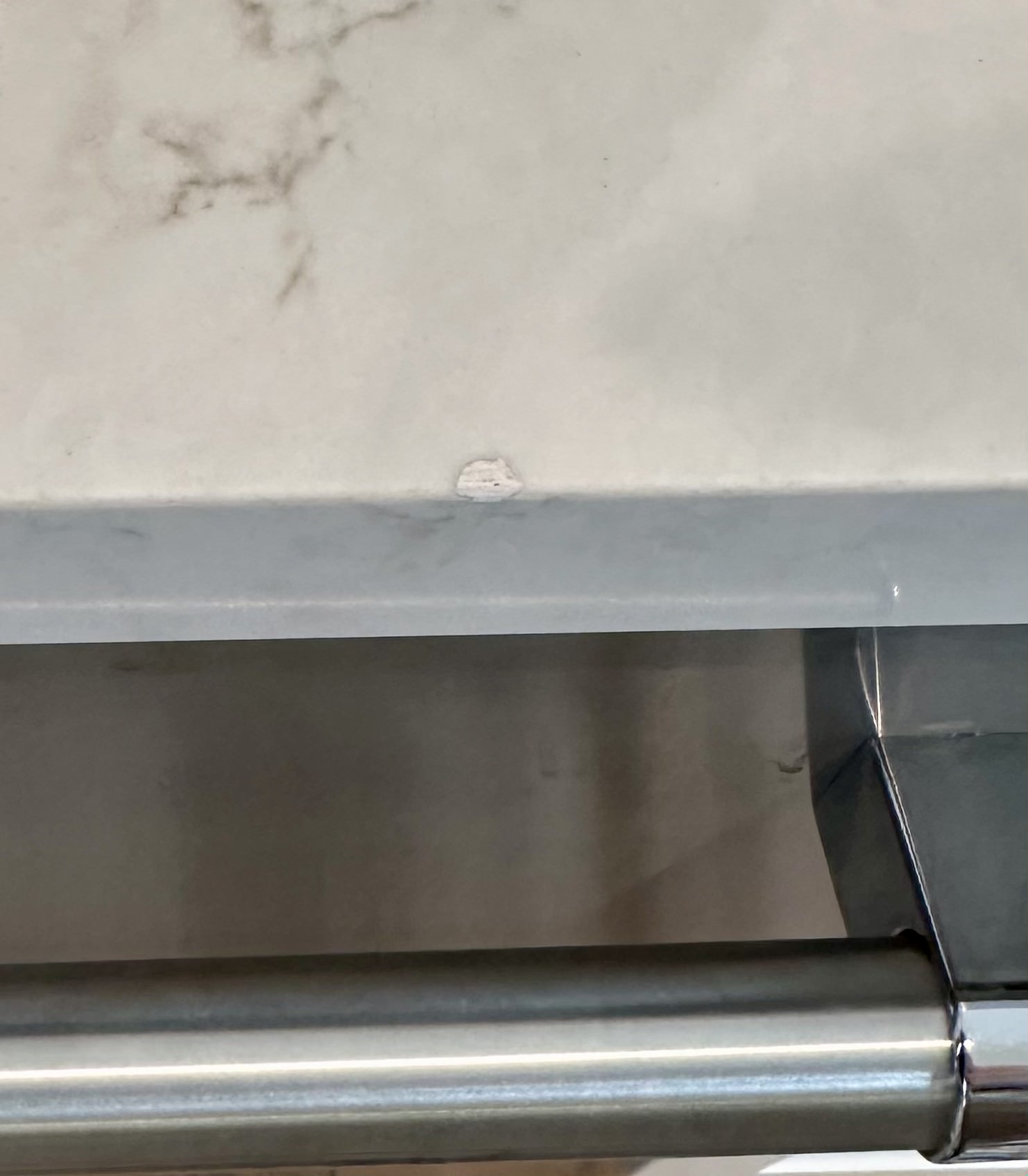 Failed chip repair by another company with discolored filler, before correction